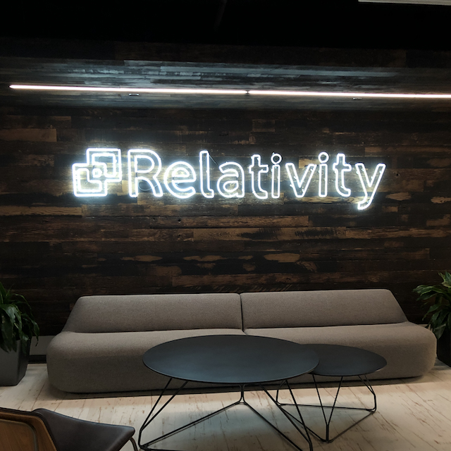 A neon sign that is lit with the word 'Relativity'