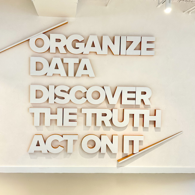 A neon sign that is lit with the word 'Relativity'